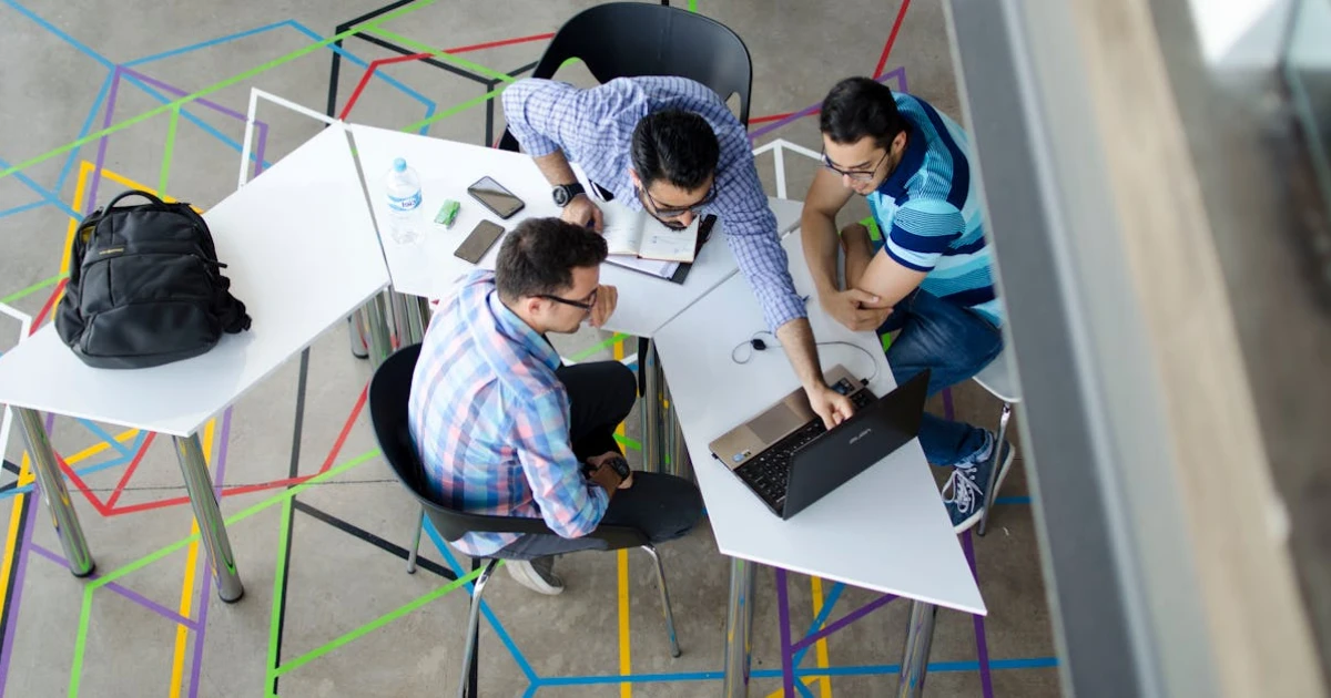 Top-view Photo of 3 Men in Front of Laptop